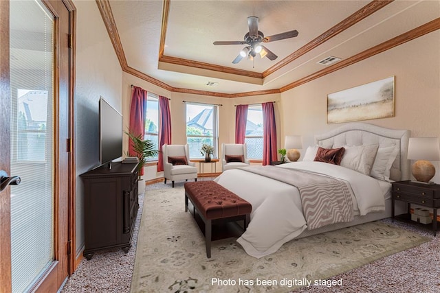 2612 SW 137th St, Oklahoma City, OK 73170 - bedroom with crown molding, a raised ceiling, light colored carpet, and a ceiling fan