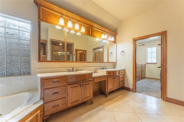 2612 SW 137th St, Oklahoma City, OK 73170 - bathroom featuring double vanity, a bath, tile patterned floors, and baseboards
