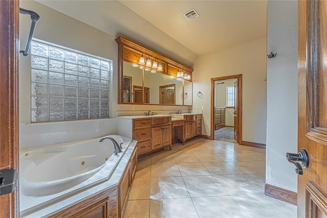 2612 SW 137th St, Oklahoma City, OK 73170 - bathroom with double vanity, a whirlpool tub, baseboards, and tile patterned flooring
