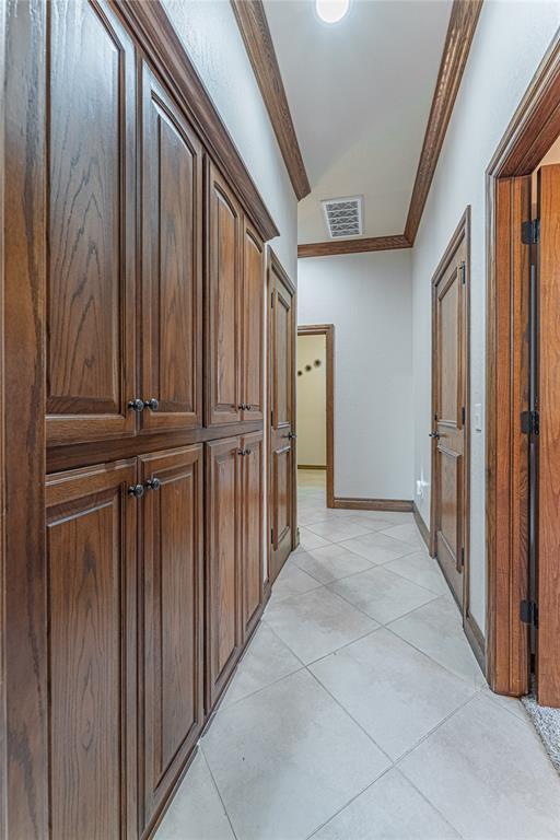 2612 SW 137th St, Oklahoma City, OK 73170 - hallway with light tile patterned floors, crown molding, and baseboards
