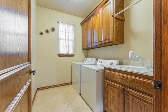 2612 SW 137th St, Oklahoma City, OK 73170 - laundry area with washing machine and dryer, cabinet space, light tile patterned flooring, baseboards, and a textured ceiling