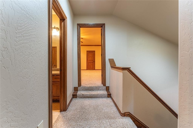2612 SW 137th St, Oklahoma City, OK 73170 - corridor featuring an upstairs landing, vaulted ceiling, light colored carpet, and a textured wall