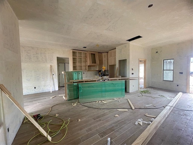 kitchen with a kitchen island, open shelves, light wood-style floors, and range hood