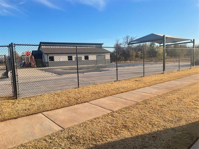 view of tennis court featuring fence