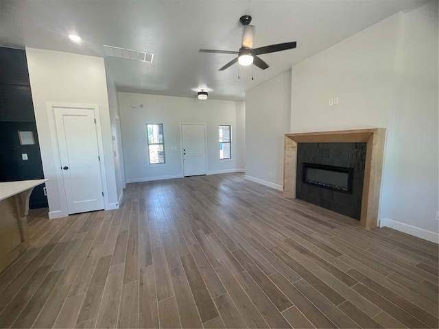 5012 Misty Wood Ln, Mustang, OK 73064 - unfurnished living room with wood finished floors, a ceiling fan, and a fireplace