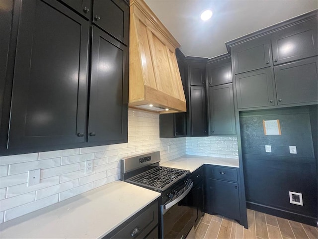 5012 Misty Wood Ln, Mustang, OK 73064 - kitchen with stainless steel gas stove, light countertops, custom exhaust hood, light wood finished floors, and tasteful backsplash