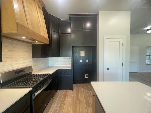5012 Misty Wood Ln, Mustang, OK 73064 - kitchen with stainless steel gas stove, premium range hood, light wood-style floors, and light countertops
