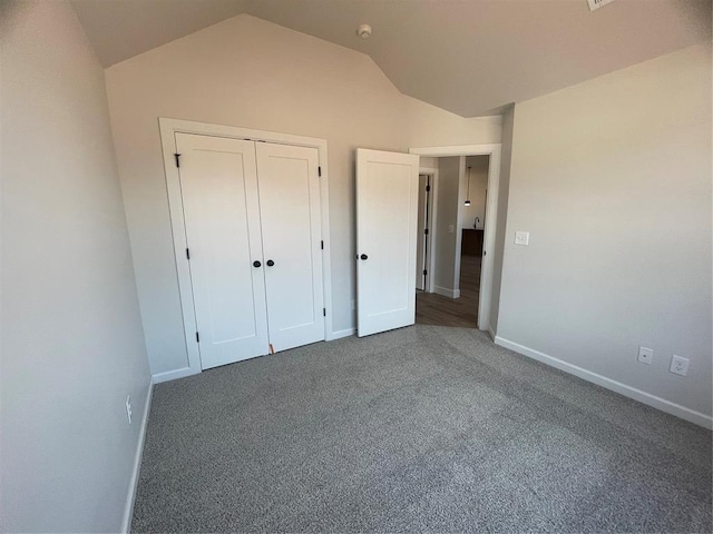 5012 Misty Wood Ln, Mustang, OK 73064 - unfurnished bedroom with vaulted ceiling, carpet, and a closet