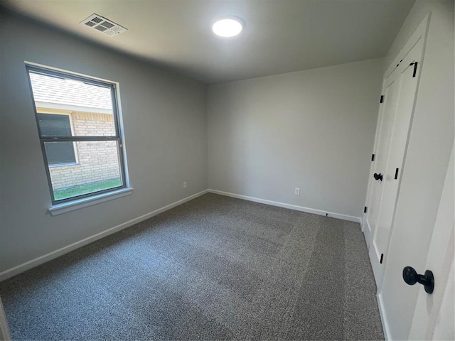 5012 Misty Wood Ln, Mustang, OK 73064 - unfurnished bedroom with carpet floors and multiple windows
