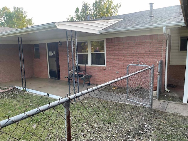329131 E Lincoln St, Harrah, OK 73045 - back of house with brick siding, roof with shingles, and a patio area