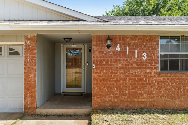 4113 Monica Dr, Del City, OK 73115 - doorway to property featuring brick siding and roof with shingles