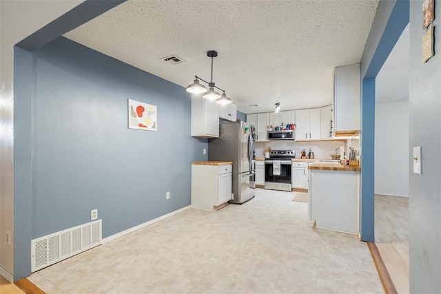 4113 Monica Dr, Del City, OK 73115 - kitchen featuring appliances with stainless steel finishes, white cabinets, a textured ceiling, tasteful backsplash, and hanging light fixtures