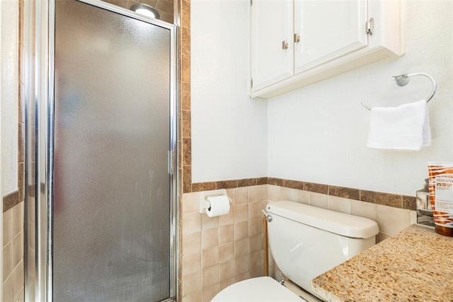 4113 Monica Dr, Del City, OK 73115 - bathroom with tile walls, a stall shower, toilet, and wainscoting