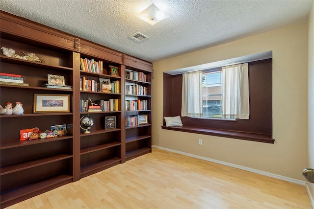 4113 Monica Dr, Del City, OK 73115 - living area featuring wood finished floors, a textured ceiling, and baseboards