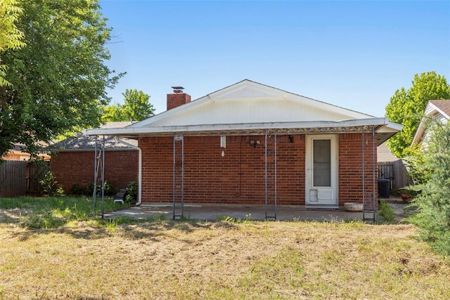 4113 Monica Dr, Del City, OK 73115 - back of house featuring a patio area, a chimney, central AC unit, and brick siding