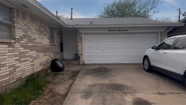 view of property exterior featuring concrete driveway, an attached garage, and brick siding