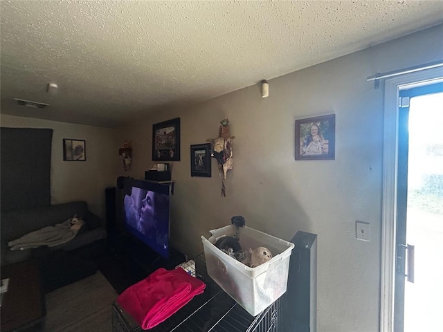 interior space with a textured ceiling and visible vents