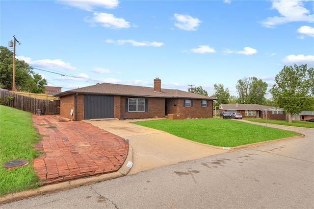 single story home featuring a chimney, fence, a front lawn, brick siding, and driveway