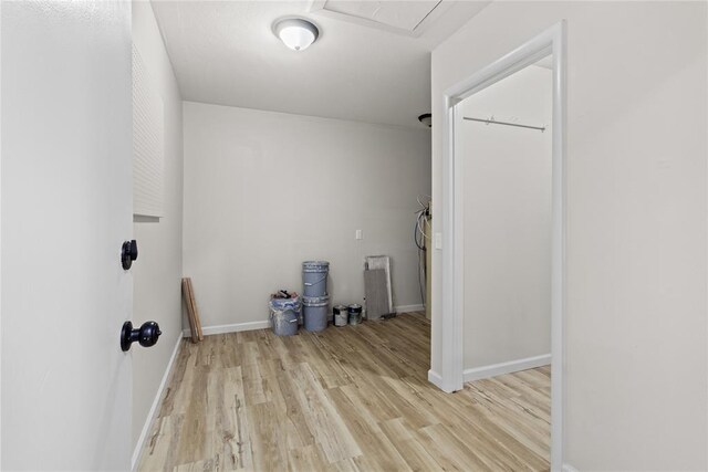 laundry room with attic access, wood finished floors, and baseboards