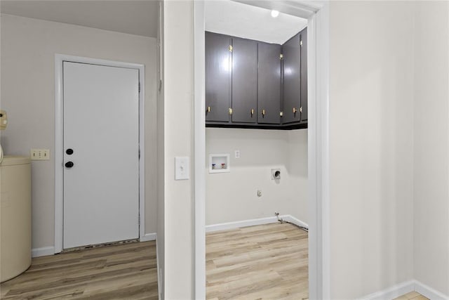 laundry area with hookup for an electric dryer, light wood finished floors, hookup for a gas dryer, and cabinet space
