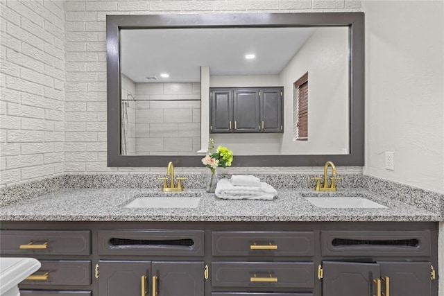 bathroom with a sink and double vanity