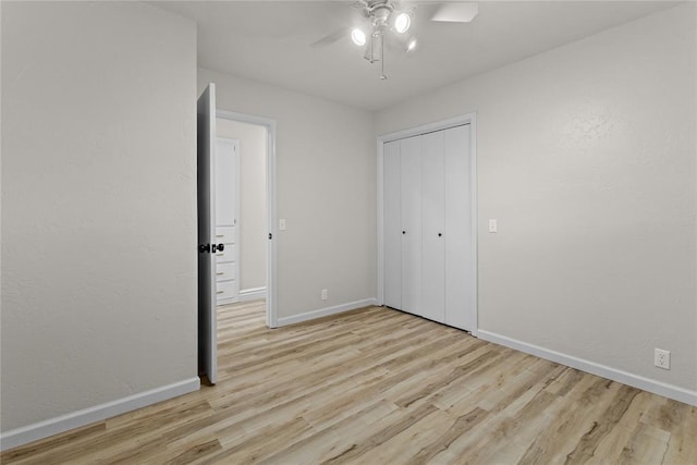 unfurnished bedroom with a closet, a ceiling fan, wood finished floors, and baseboards