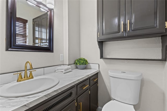 half bathroom with toilet and vanity