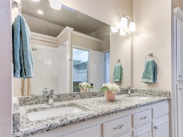 full bath featuring double vanity and a shower
