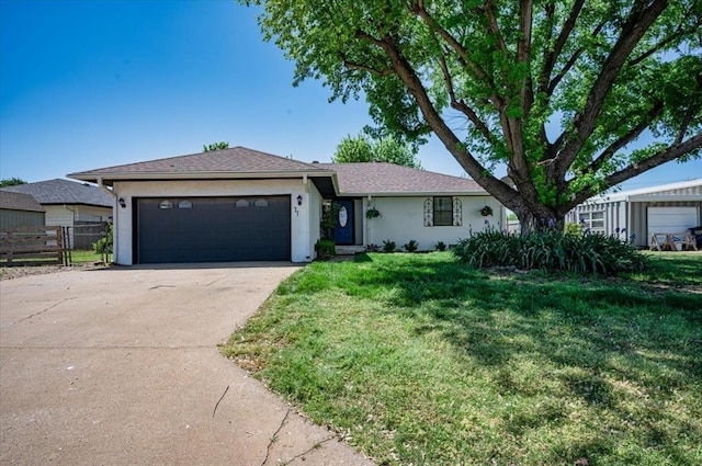 ranch-style house with driveway, fence, a garage, stucco siding, and a front lawn