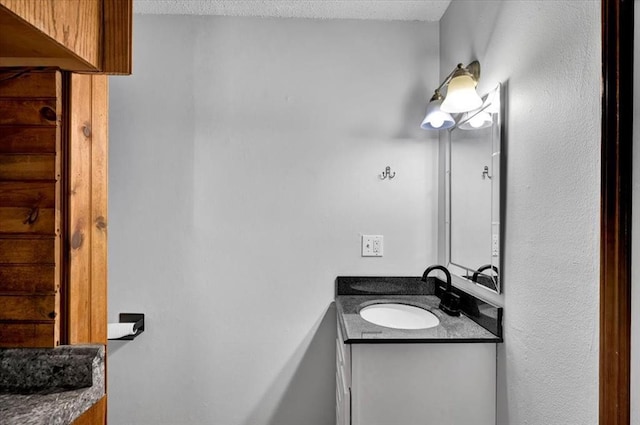 bathroom featuring vanity and a textured ceiling