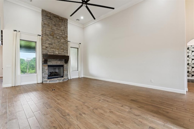 1111 Colonial Ave, Tuttle, OK 73089 - unfurnished living room featuring a ceiling fan, baseboards, ornamental molding, wood finished floors, and a fireplace