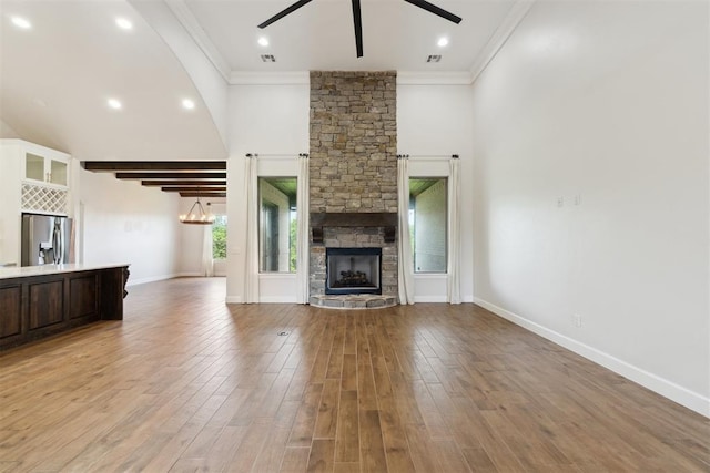 1111 Colonial Ave, Tuttle, OK 73089 - unfurnished living room with light wood-type flooring, crown molding, a fireplace, and ceiling fan
