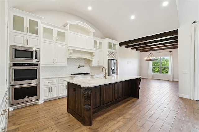 1111 Colonial Ave, Tuttle, OK 73089 - kitchen featuring white cabinetry, appliances with stainless steel finishes, decorative backsplash, and light wood-type flooring