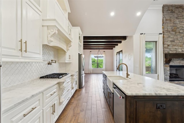 1111 Colonial Ave, Tuttle, OK 73089 - kitchen with a sink, stainless steel appliances, an island with sink, dark wood-style floors, and white cabinets