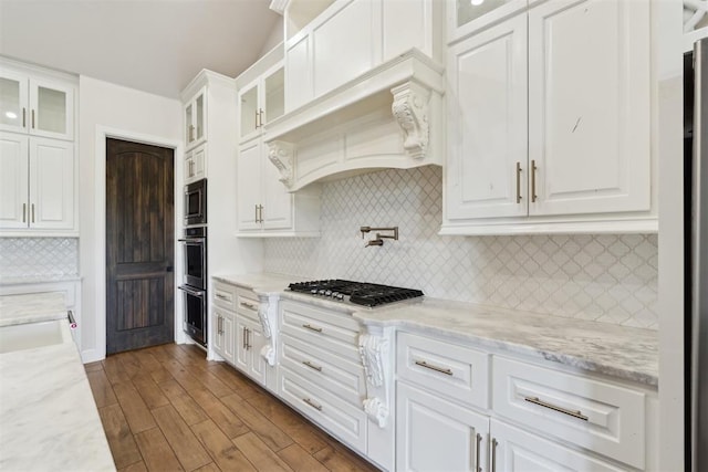 1111 Colonial Ave, Tuttle, OK 73089 - kitchen featuring stainless steel appliances, dark wood finished floors, decorative backsplash, glass insert cabinets, and white cabinets