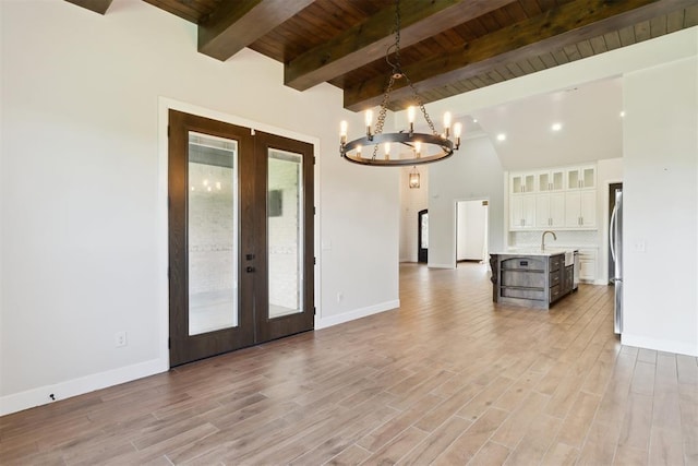 1111 Colonial Ave, Tuttle, OK 73089 - interior space with french doors, wooden ceiling, an inviting chandelier, light wood finished floors, and beamed ceiling