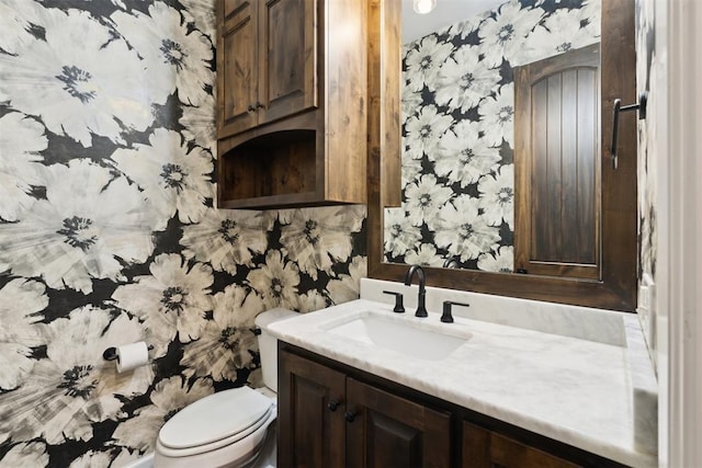 1111 Colonial Ave, Tuttle, OK 73089 - bathroom featuring vanity, toilet, and wallpapered walls