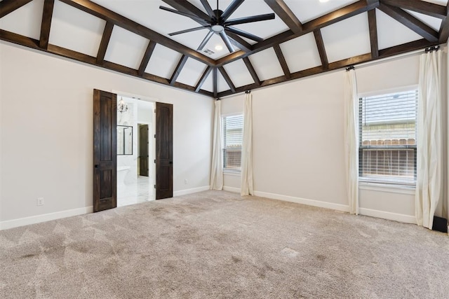 1111 Colonial Ave, Tuttle, OK 73089 - unfurnished bedroom featuring carpet flooring, vaulted ceiling with beams, visible vents, baseboards, and ensuite bath