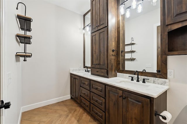 1111 Colonial Ave, Tuttle, OK 73089 - bathroom featuring double vanity, baseboards, and a sink