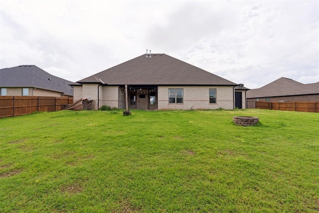 1111 Colonial Ave, Tuttle, OK 73089 - back of house with a yard, a fire pit, and a fenced backyard