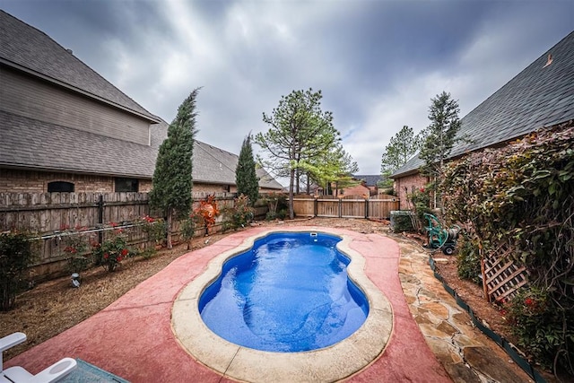 view of swimming pool with a patio area, a fenced backyard, and a fenced in pool