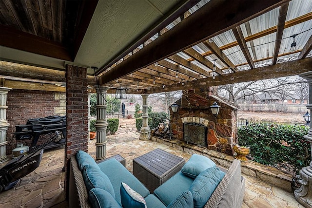 view of patio featuring an outdoor living space with a fireplace and a pergola