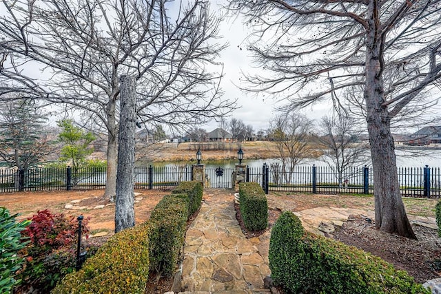 view of front facade with a water view and fence private yard