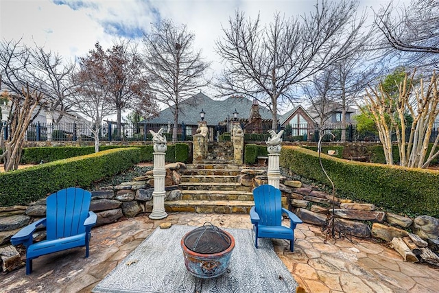 view of patio / terrace with an outdoor fire pit and fence