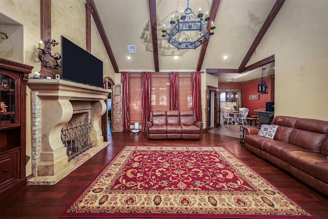 living area featuring wood-type flooring, visible vents, a chandelier, lofted ceiling with beams, and a fireplace