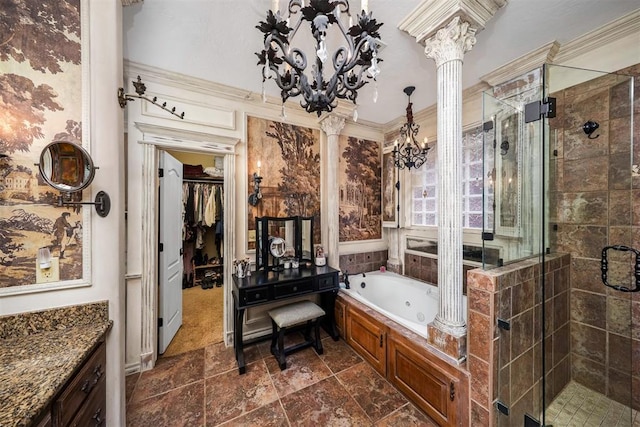 full bathroom featuring stone finish floor, a shower stall, a jetted tub, a chandelier, and ornate columns