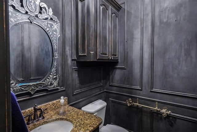 half bath featuring toilet and vanity