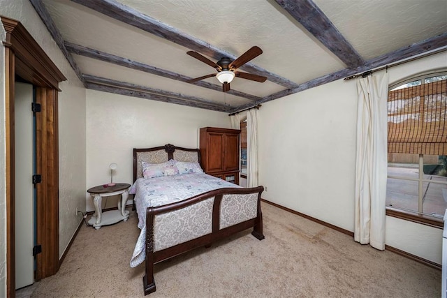 bedroom featuring light colored carpet, baseboards, a ceiling fan, and beam ceiling