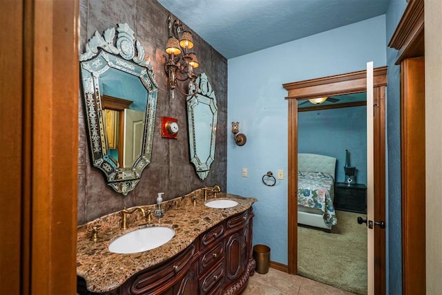 bathroom featuring a sink, double vanity, ensuite bath, and tile patterned floors