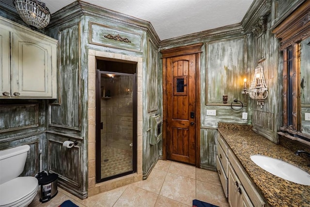 full bath featuring a stall shower, toilet, an inviting chandelier, tile patterned flooring, and vanity